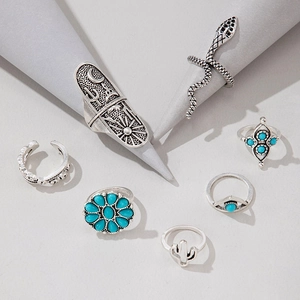 Detailed close-up of vintage silver ring set with turquoise stones and bohemian engravings