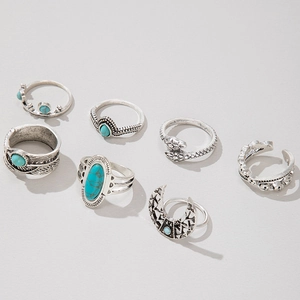 Detail showing bohemian antique silver rings with turquoise insets and feather carvings