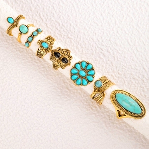 Detail view of bohemian vintage gold rings with turquoise stones and floral engravings