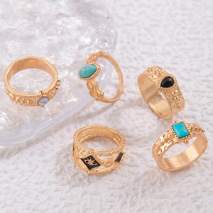 Detail of vintage gold ring set with turquoise stones and evil eye hollow design