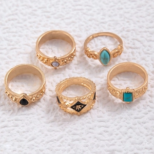 Detail of five-piece vintage turquoise ring set with bohemian floral and crown motifs