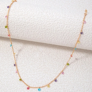 French vintage style gold necklace featuring colorful round stones on a white background