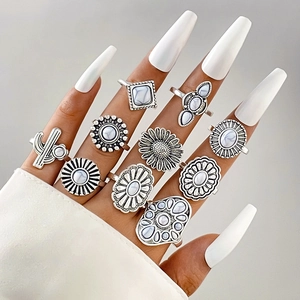Close-up of bohemian silver rings with turquoise stones worn on model hand