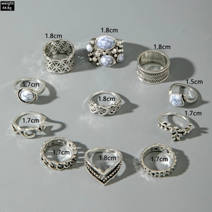 Detail view of 11-piece vintage silver ring set with marble stones and diverse patterns