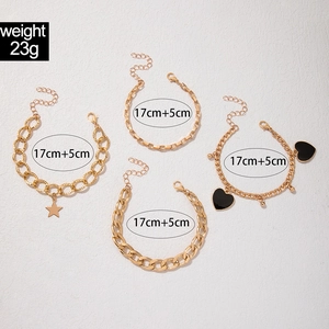 Detailed view of 4-piece gold geometric bracelets set with rhinestones and star charms