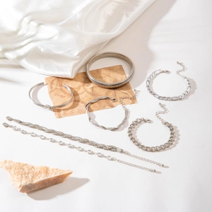 Detailed view of 7-piece silver geometric bracelet set with rhinestones and textured bands