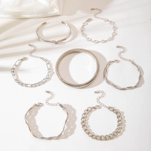 Detailed view of a 7-piece silver geometric bracelet set with layered chain styles