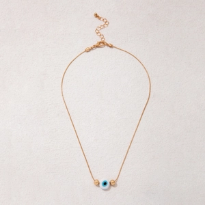 Detail of gold evil eye pendant necklace with lobster clasp and adjustable extension chain