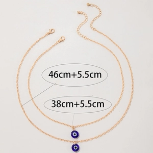 Detailed view of layered gold evil eye necklaces with 38cm and 46cm length dimensions