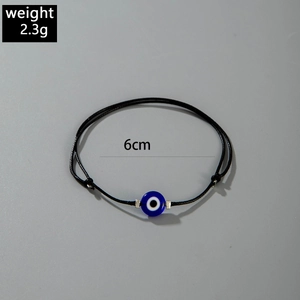 Detail shot of 2.3g adjustable black braided bracelet with blue Evil Eye bead