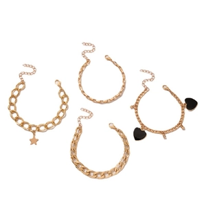 Set of four gold-tone geometric bracelets featuring star and black heart pendants