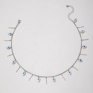 Macro shot of silver evil eye and hammered metal bar pendants on an adjustable chain