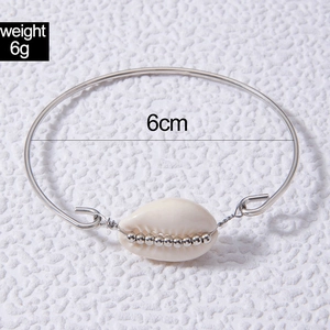 Detail of silver shell bangle showing 6g weight and 6cm diameter on a white background