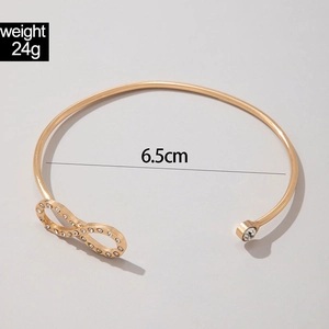 Detailed view of infinity charm gold open bangle with 6.5cm diameter and 24g weight