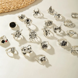 Detailed flat lay of vintage gothic silver rings with skull, spider and butterfly motifs