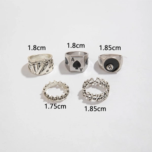 Close-up of vintage punk rings featuring poker cards, spades, and billiard ball motifs