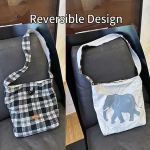 Reversible canvas tote bag featuring black plaid and blue elephant print design