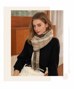 Dettaglio di sciarpa a quadri morbida con frange beige e nere, accessorio invernale