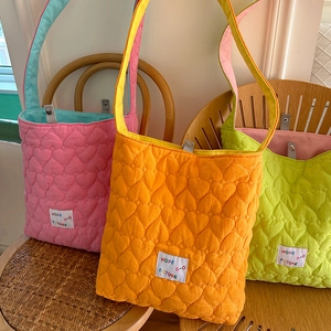 Close-up of heart-quilted candy color tote bags with hope future patch detail