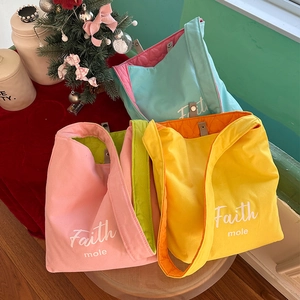 Close-up of quilted color-block canvas crossbody bags with Faith mole print and magnetic buckle