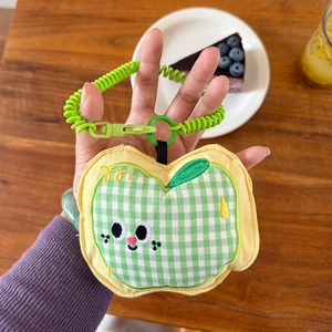 Detail of cute apple-shaped fabric earphone pouch with green spiral lanyard
