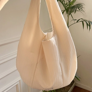 Detailed view of off-white pleated tote bag with fine vertical rib texture
