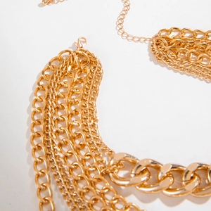 Detailed close-up of triple-layered gold alloy chain necklace with lobster clasp and lock charm