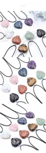Macro detail of wire-wrapped Tree of Life amethyst heart pendant on black braided cord