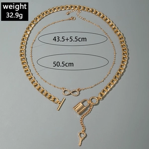 Detail of gold-layered necklace with heart key lock pendant and OT buckle design