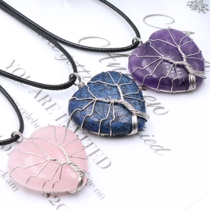Three heart-shaped gemstone necklaces with silver wire-wrapped tree of life design