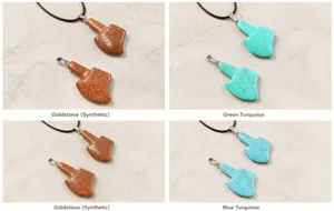 Detail view of axe-shaped pendants in synthetic goldstone, blue turquoise and tiger eye