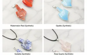 Detailed views of axe-shaped stone pendants in rose quartz, opal, and blue spot jasper
