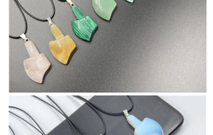 Close-up of geometric natural stone pendants in quartz and agate with black cord
