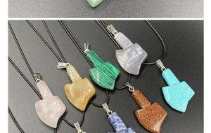 Detailed close-up of colorful gemstone axe pendants with woven cords in various stone materials