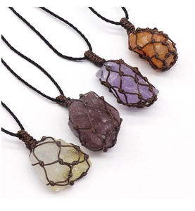 Détail de quatre pendentifs en cristal faits main dans des pochettes en filet