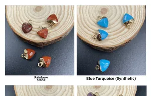 Detail of heart-shaped rainbow stone and turquoise pendants with gold plated clasps