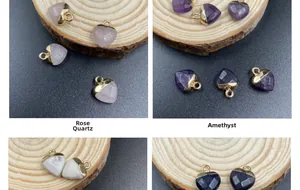 Macro detail of faceted heart crystal pendants with gold edges in various gemstones