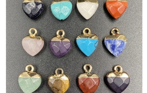 Detailed grid of multifaceted heart-shaped stone pendants with gold-plated metal loops