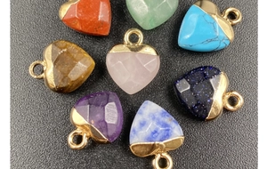 Detailed close-up of heart-shaped natural gemstone pendants with gold-plated metal caps