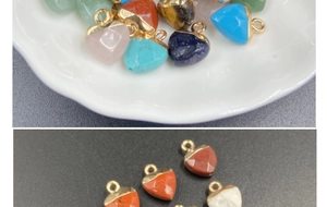 Macro view of assorted heart-shaped semi-precious stone pendants with gold plated edges