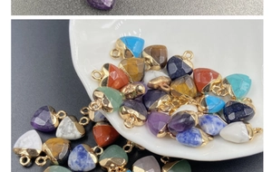 Close-up of heart-shaped semi-precious crystal pendants with gold-plated metal edges