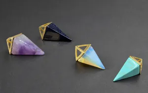 Detailed view of pyramid crystal pendants in amethyst and tiger eye with gold clasps