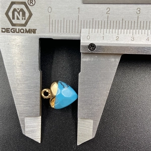 Blue heart crystal pendant with gold-plated edges showing 11.5mm size on a caliper