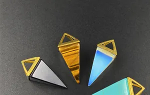 Detailed set of four triangular prism crystal pendants in tiger eye and gemstone textures