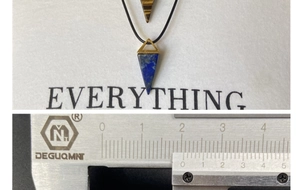 Detail view of triangular crystal pendants measured with a caliper for 1.5cm width