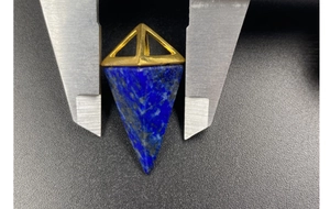 Lapis lazuli geometric cone pendant measured by caliper showing dimensions for accuracy