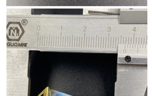 Detail view showing a 27.5mm measurement of the geometric crystal pendant with gold plating