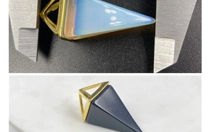 Macro shot measuring 3cm pyramid gemstone pendants with gold caps and calipers