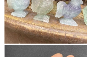 Detailed view of hand-carved natural fluorite rooster figurine with green and purple tones