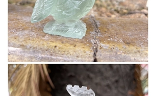 Macro detail of hand-carved green fluorite gemstone rooster statue with natural mineral texture
